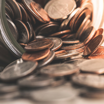 photo of coins falling out of glass jar