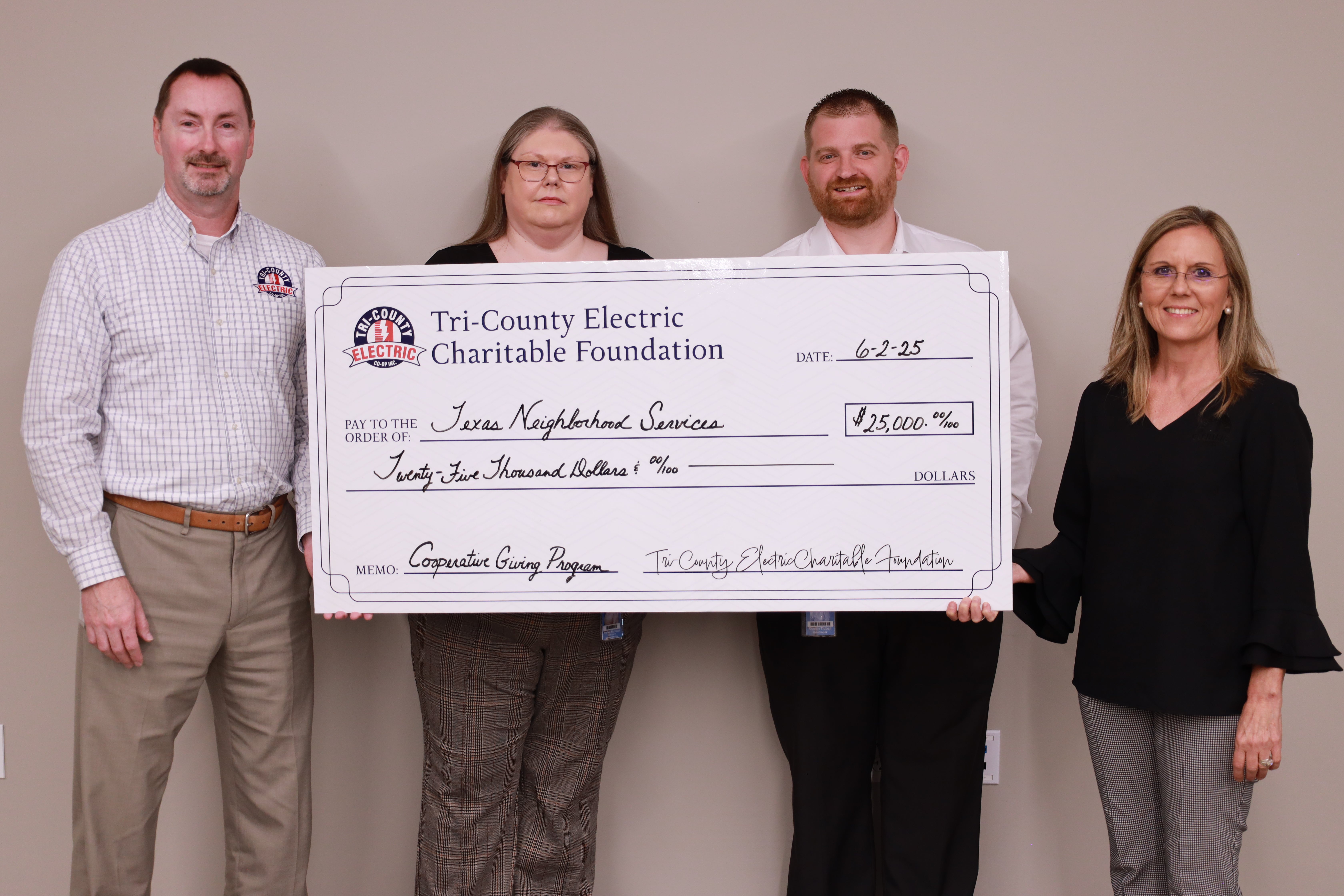 TCEC leadership poses with check to Texas Neighborhood Services