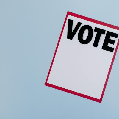 decorative photo of sheet of paper that says "vote"