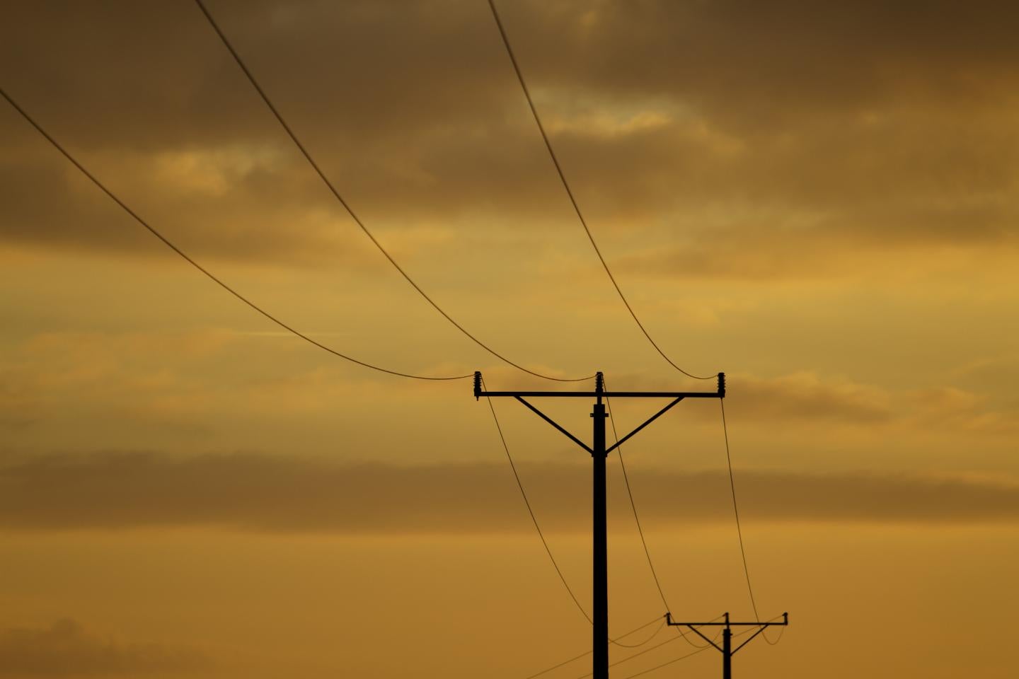 decorative photo of electric lines against a dark sky background
